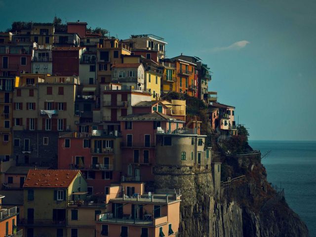 Cliffside town stacked above the sea at golden hour.